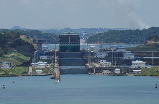 Cargo vessels transit through the Panama Canal, in Colon