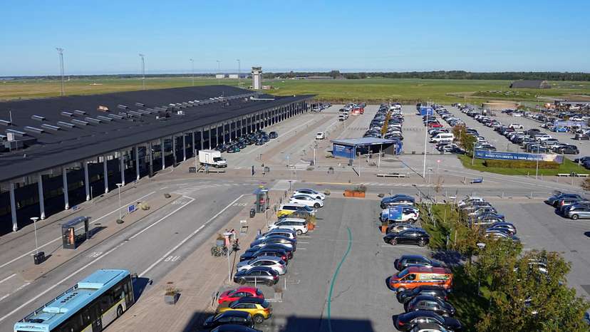 Vehicles are parked at Aalborg Airport
