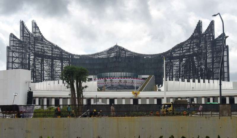Workers construct the pedestrian walkway near the State Palace and the eagle-shaped Garuda Palace in the Nusantara National Capital (IKN)