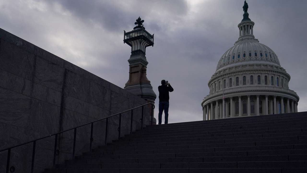 FILE PHOTO: A man uses his mobile phone near the U.S. Capitol in Washington