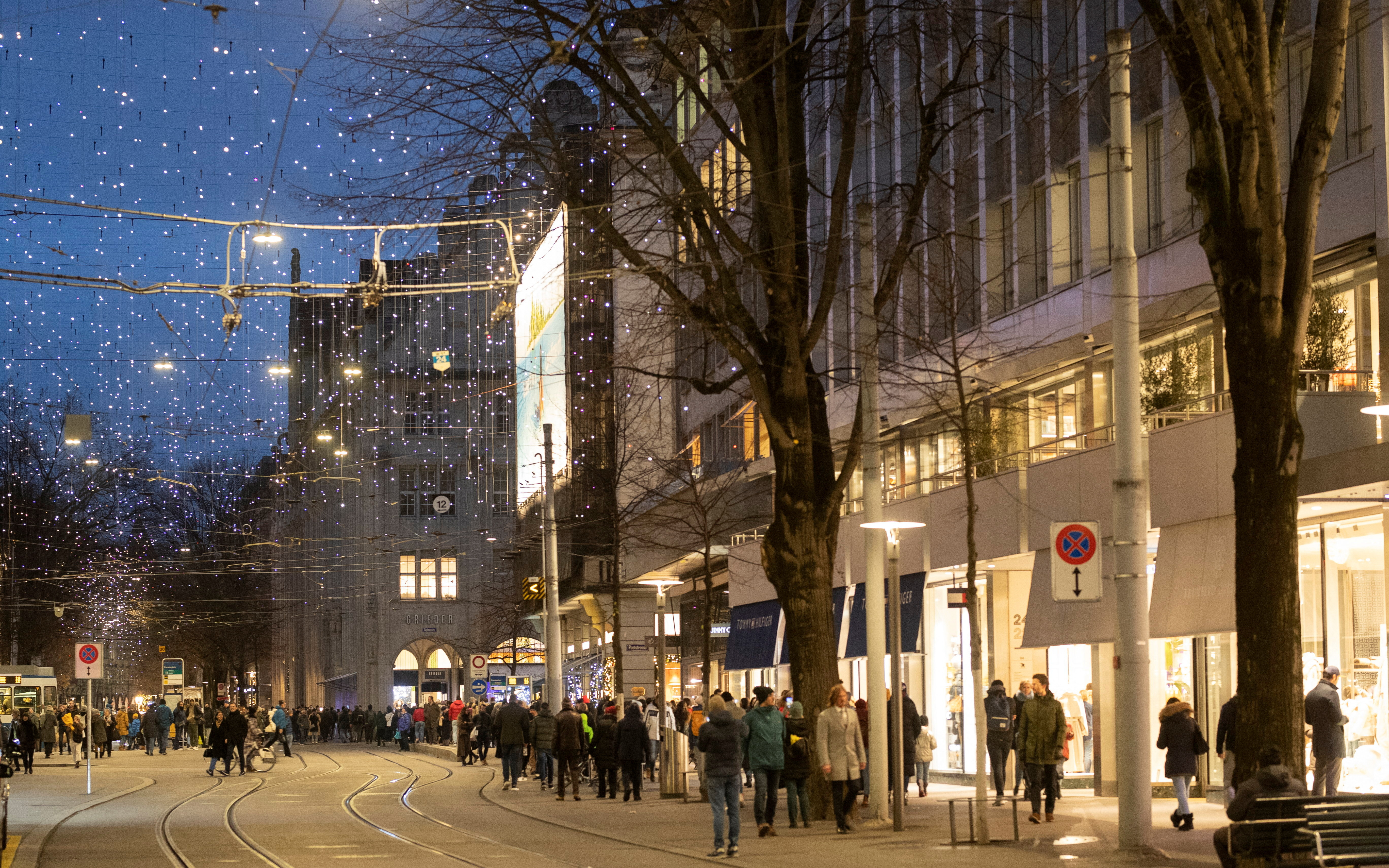 People walk under Christmas illuminations on Bahnhofstrasse shopping street in Zurich