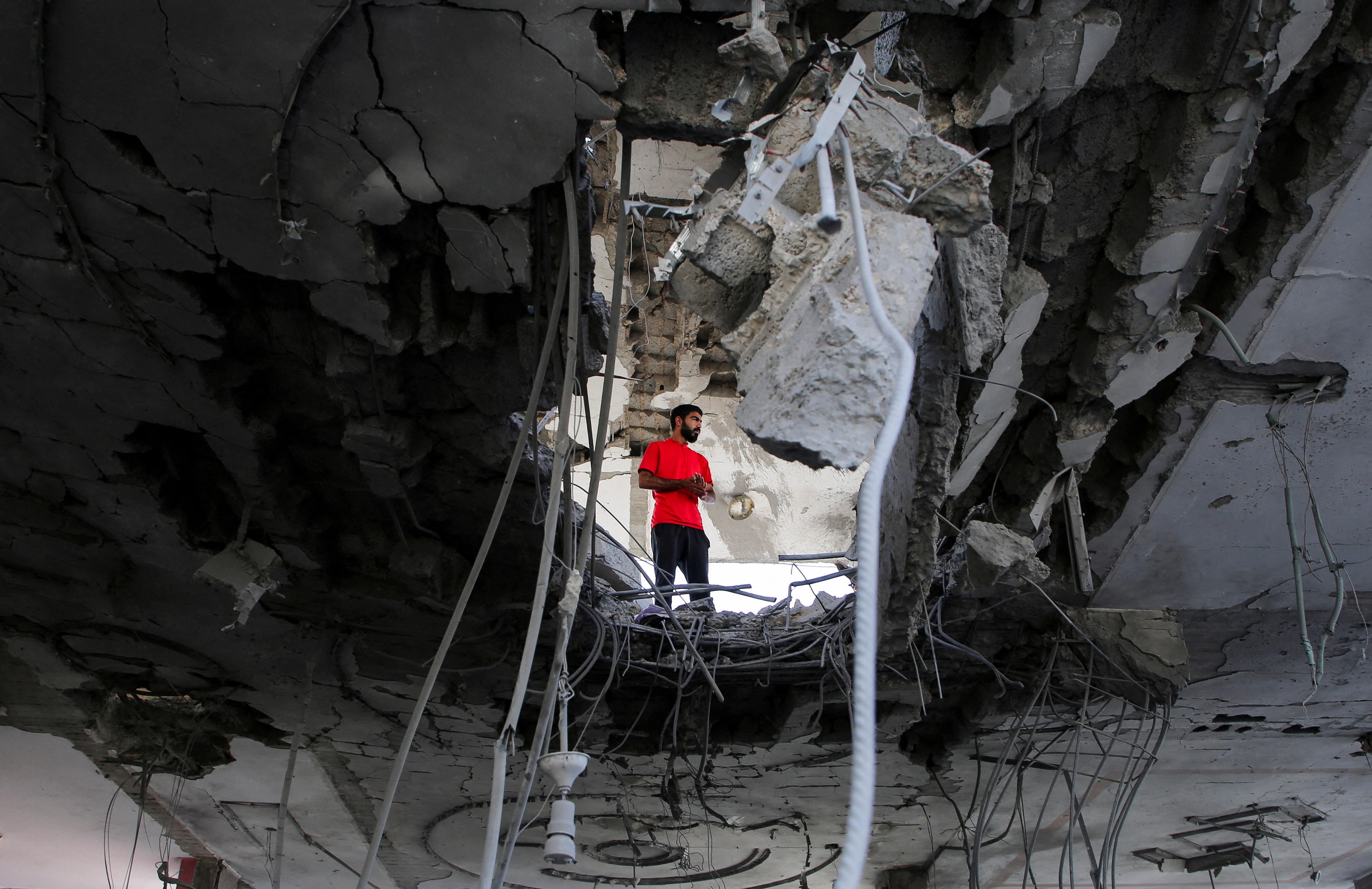 A person stands inside a building, damaged in an Israeli strike, amid the ongoing conflict between Israel and the Palestinian Islamist group Hamas, in Rafah