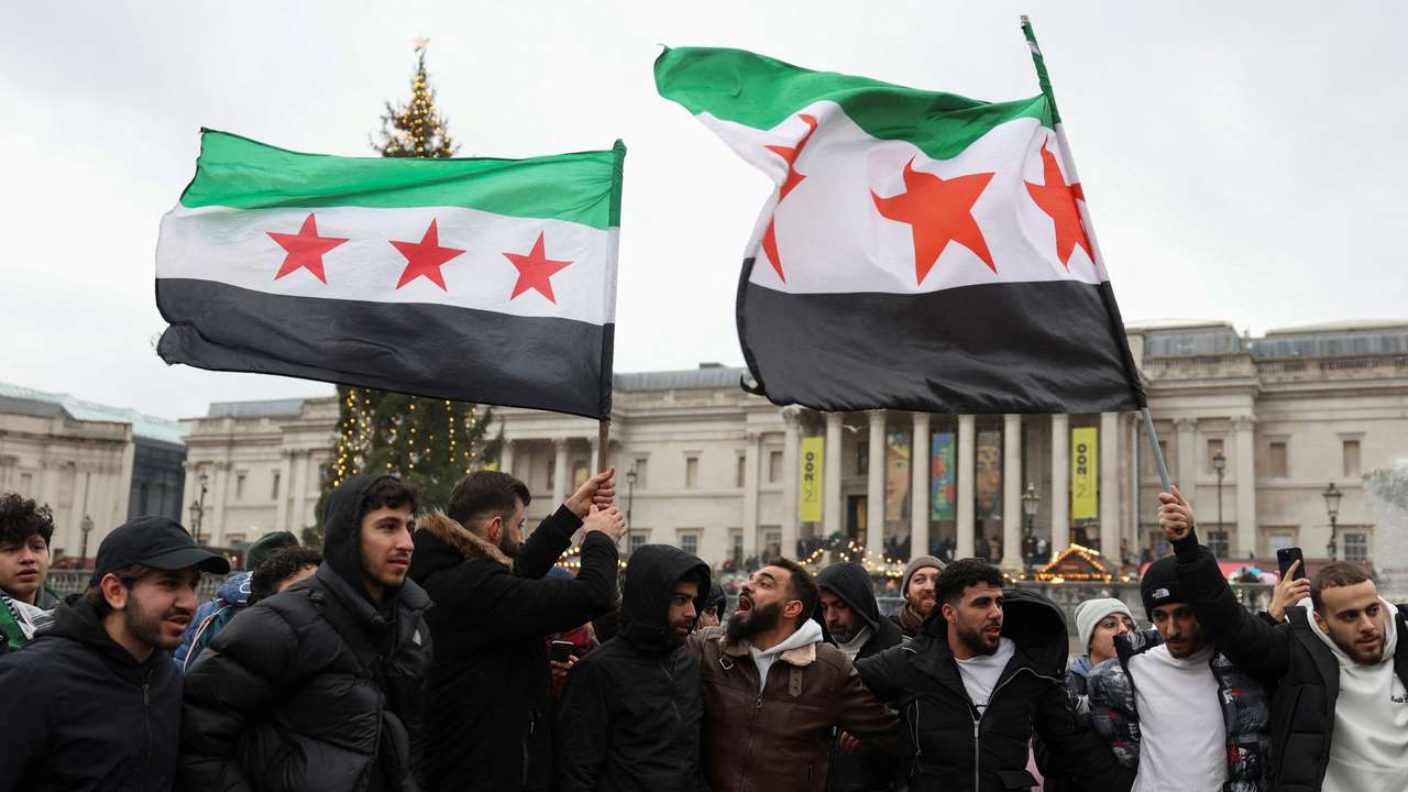 FILE PHOTO: People gather in Trafalgar Square, after Syrian rebels announced that they have ousted Syria's Bashar al-Assad, in London
