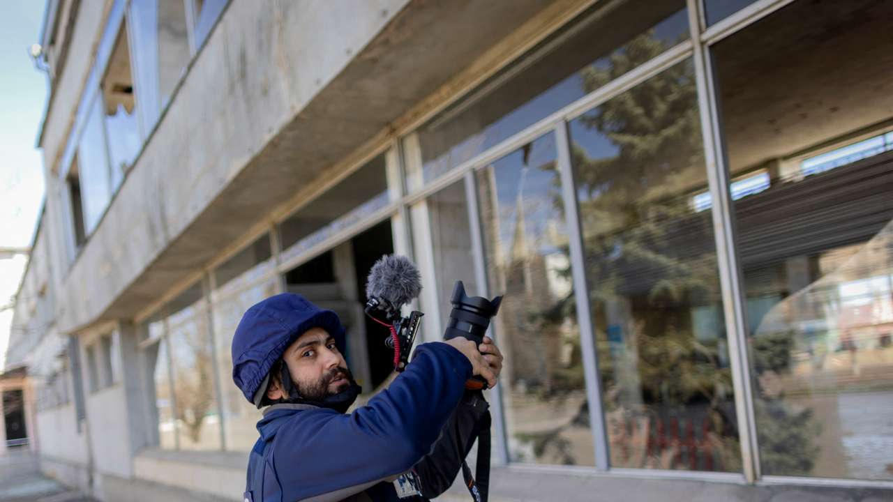 FILE PHOTO: Reuters' journalist Issam Abdallah films during an assignment at a damaged train station in Mykolaiv