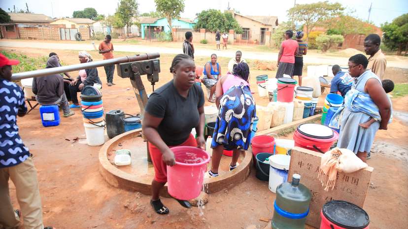 Residents fetch drinking water from a borehole in Marondera