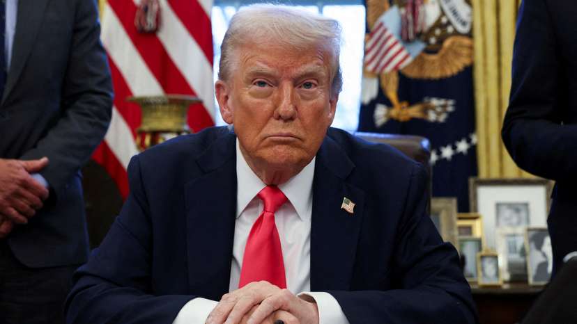 U.S. President Donald Trump signs an executive order in the Oval Office, at the White House in Washington