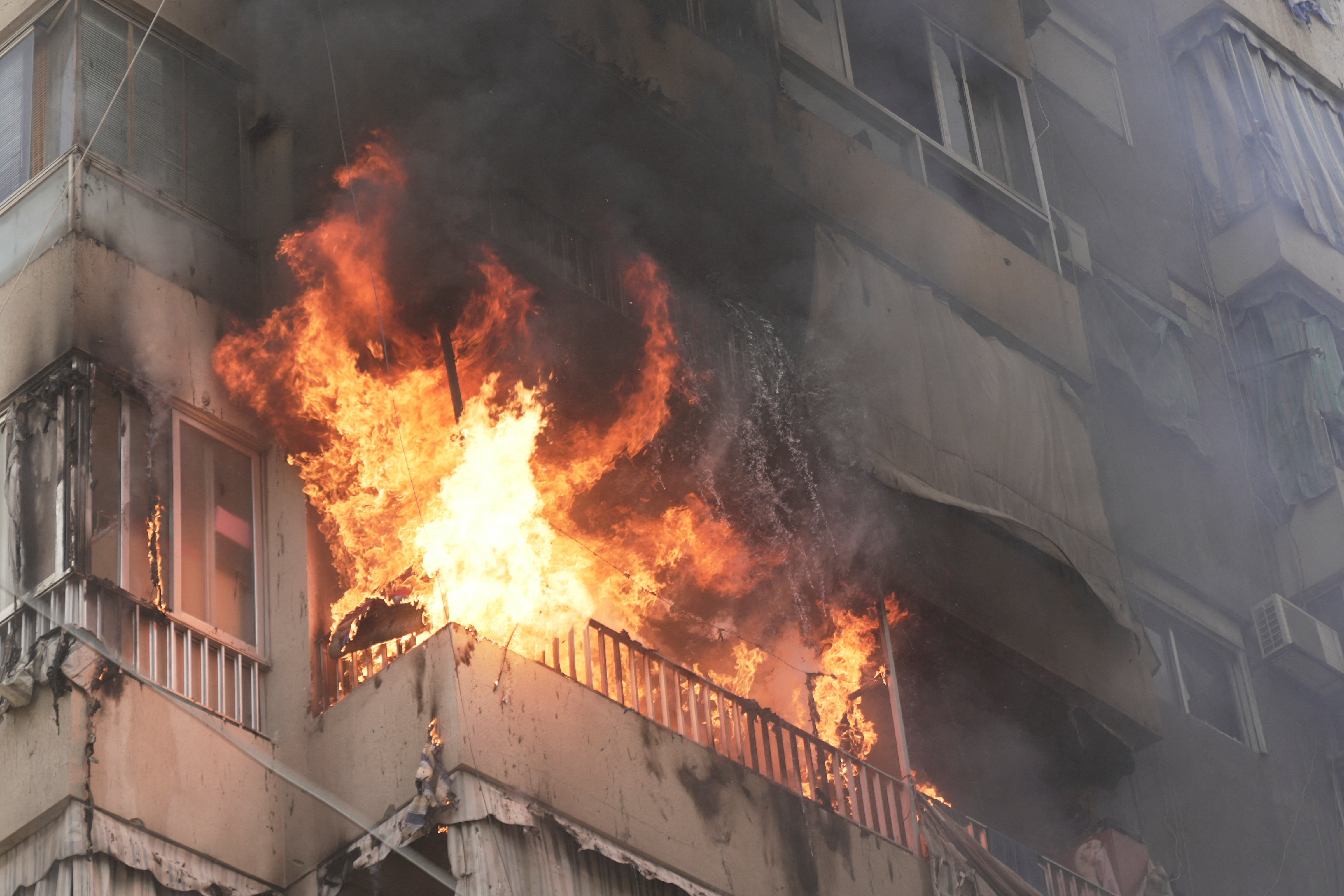 Flames engulf a building following an Israeli air strike in Beirut