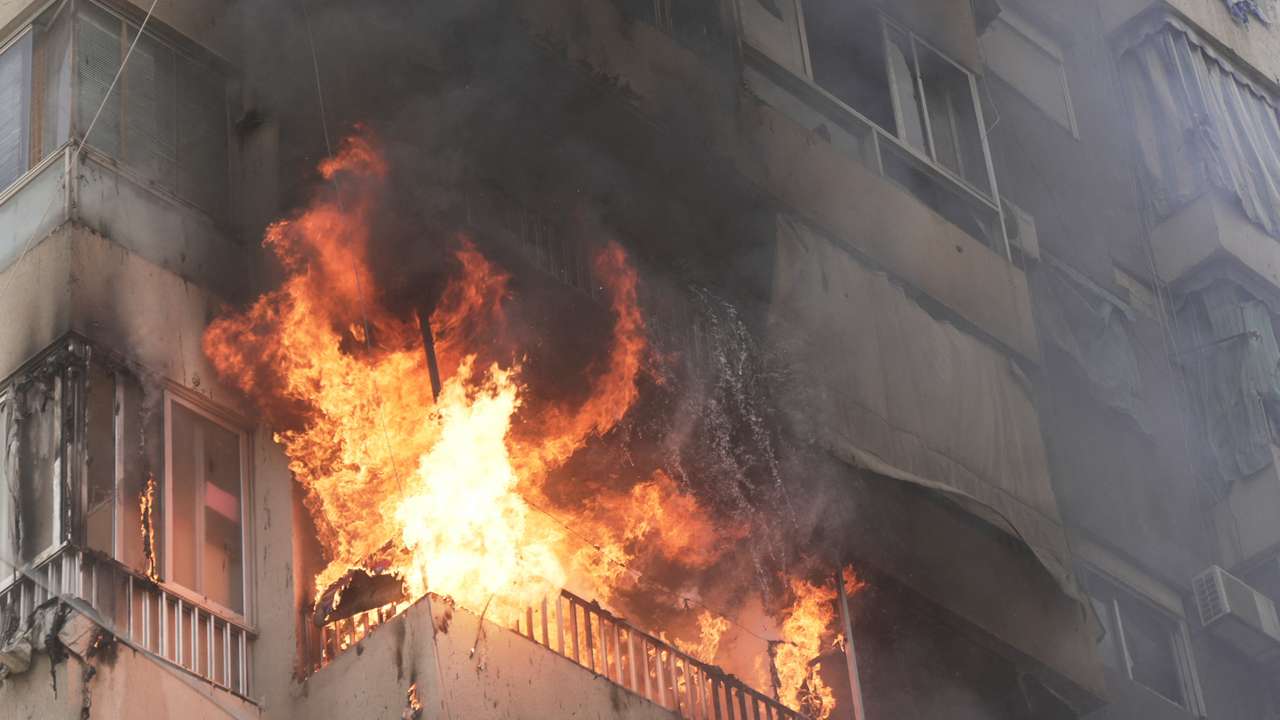 Flames engulf a building following an Israeli air strike in Beirut