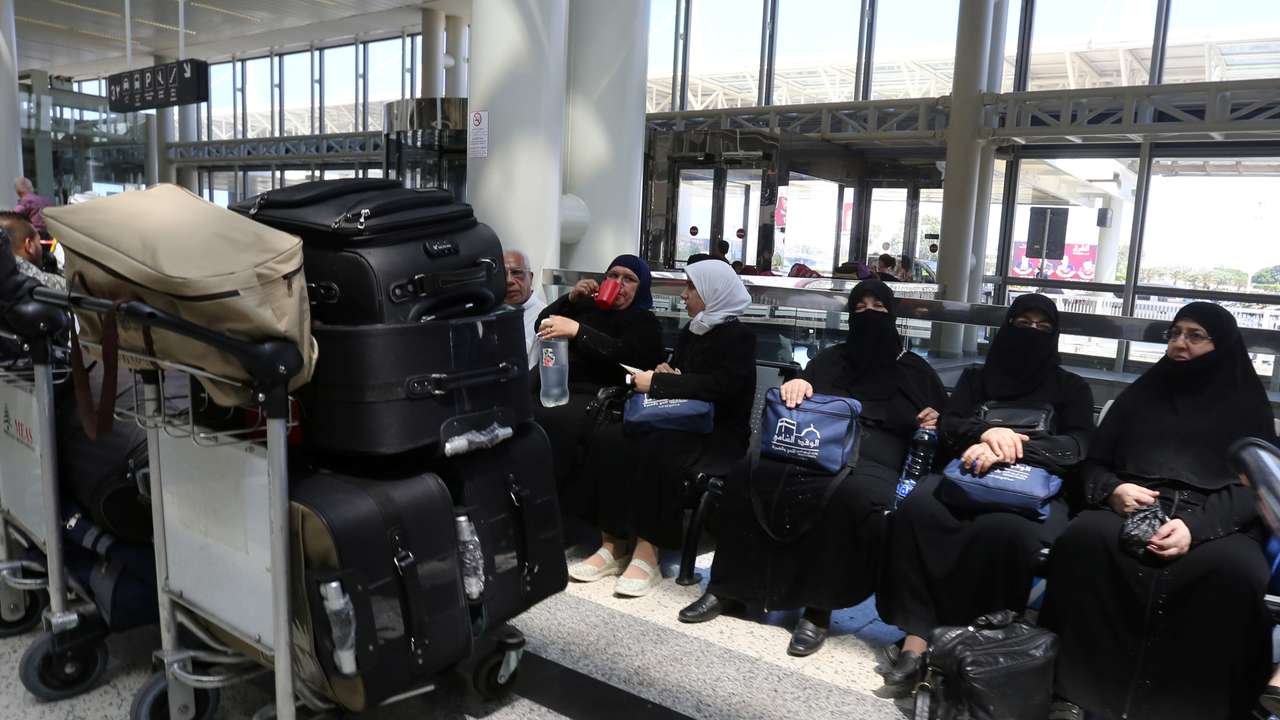 FILE PHOTO: Syrian Haj pilgrims heading to Mecca wait to board an airplane at Beirut international airport