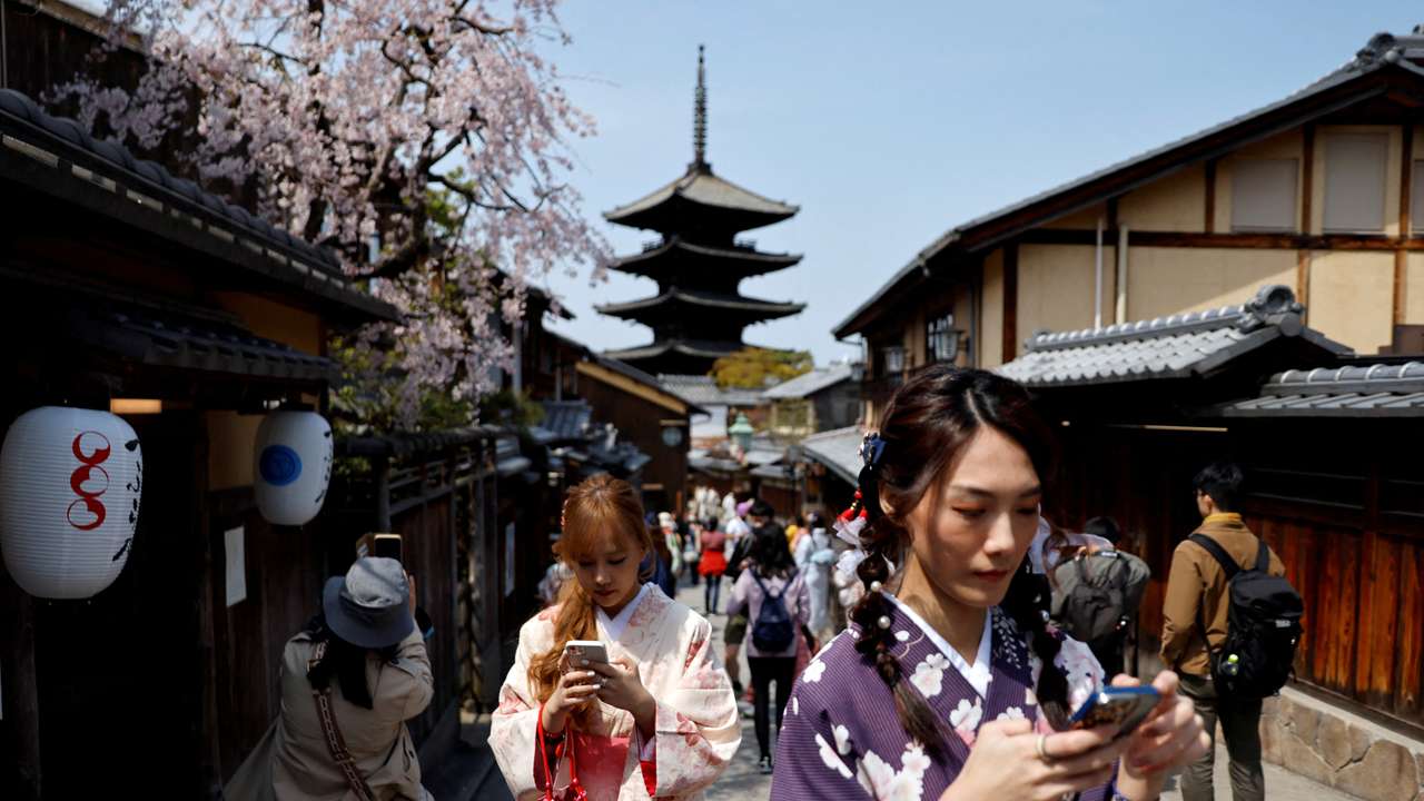 FILE PHOTO: A crowd of tourists walk on the street near Kiyomizu-dera temple in Kyoto