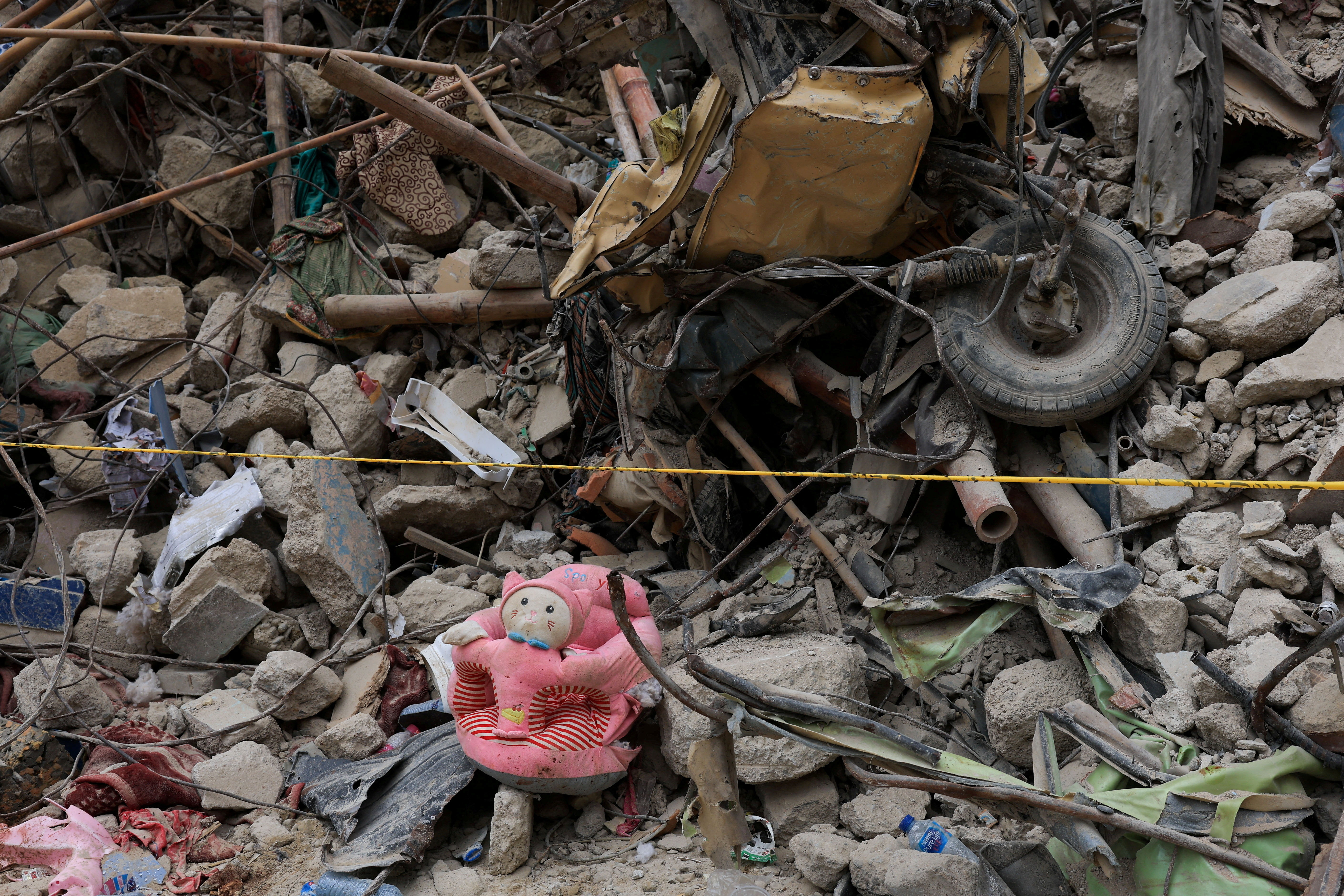 Personal belongings lie amid the rubble of a five-storey residential building that collapsed on Friday, July 4, in Karachi