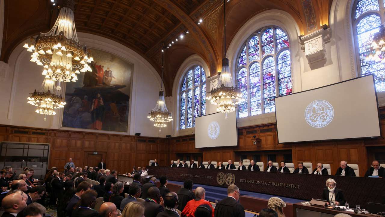 People sit inside the International Court of Justice (ICJ) on the day of the trial to hear a request for emergency measures by South Africa, who asked the court to order Israel to stop its military actions in Gaza, in The Hague