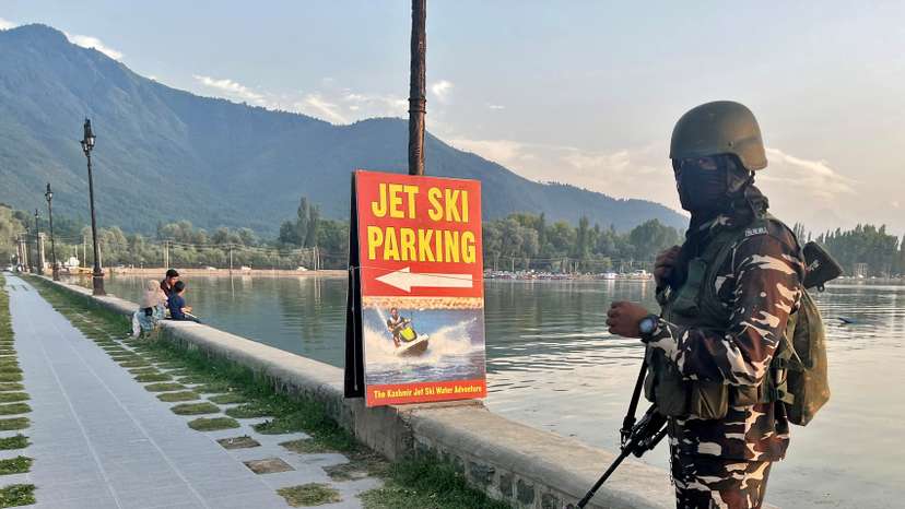 An Indian security force personnel stands guard on the banks of Dal Lake in Srinagar