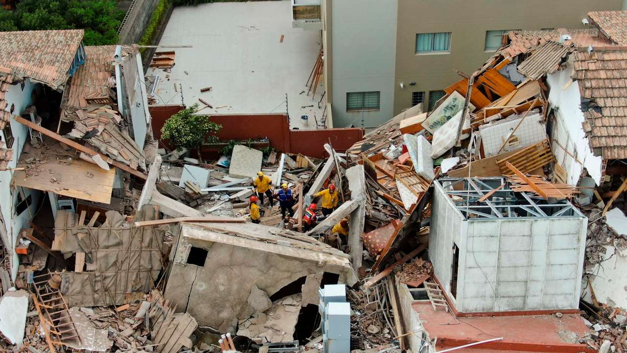 Firefighters search for trapped people after a hotel collapses in Villa Gesell
