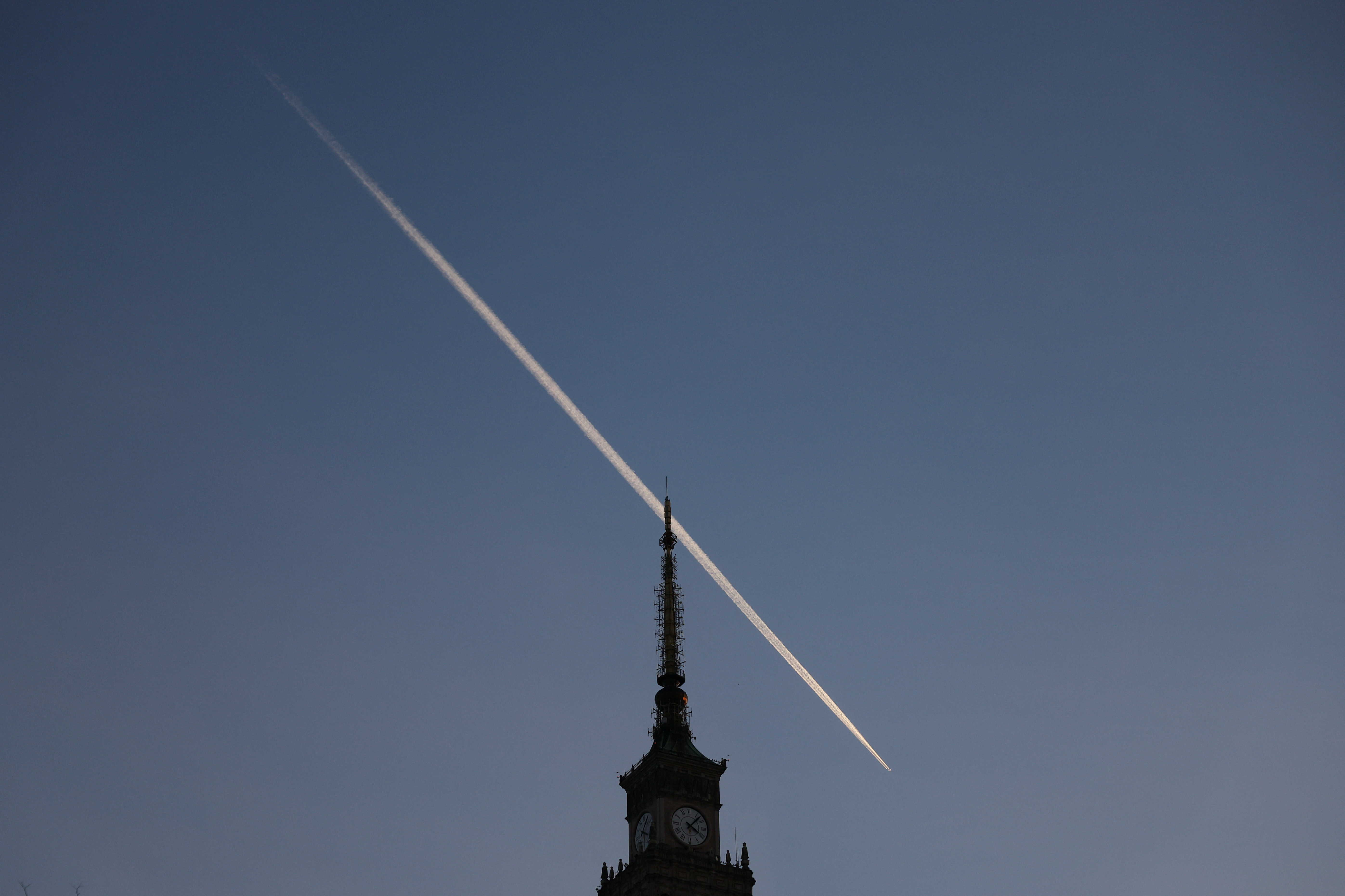 Plane trail above Palace of Culture in Warsaw