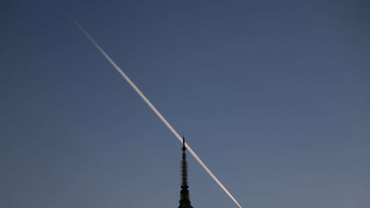 Plane trail above Palace of Culture in Warsaw
