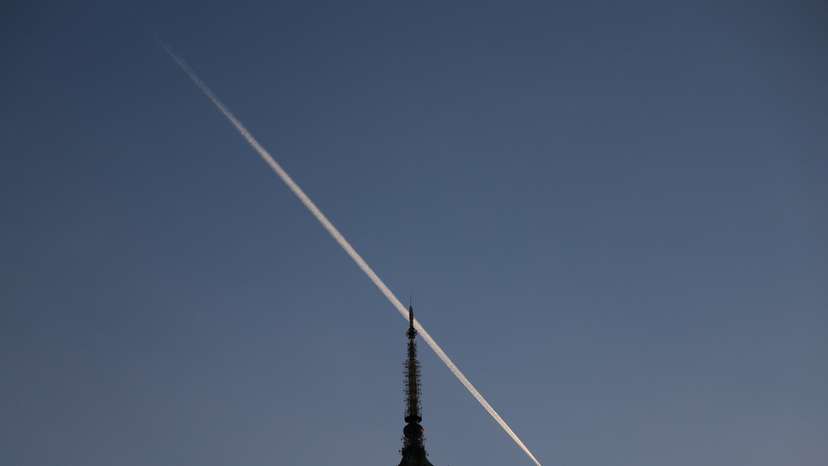 Plane trail above Palace of Culture in Warsaw