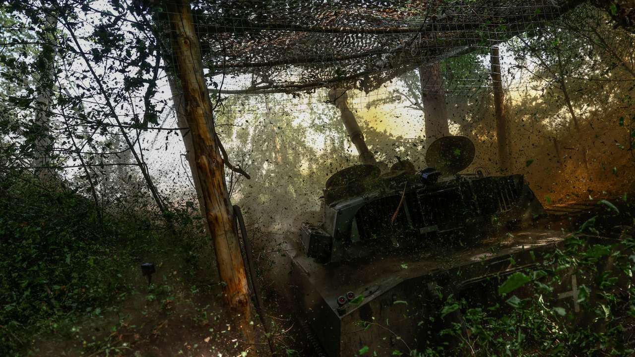 Ukrainian servicemen fire a self-propelled howitzer towards Russian troops in a front line in Kharkiv region