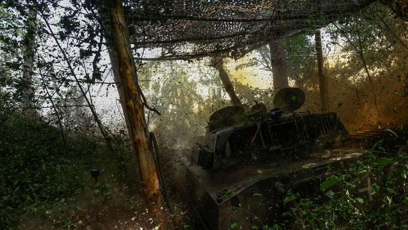 Ukrainian servicemen fire a self-propelled howitzer towards Russian troops in a front line in Kharkiv region