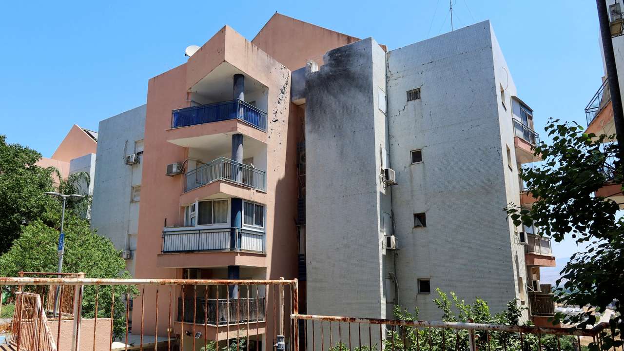 Damage to a residential building after Hezbollah fired a barrage of projectiles towards Israel from Lebanon, amid cross-border hostilities between Hezbollah and Israeli forces, near Kiryat Shmona in northern Israel