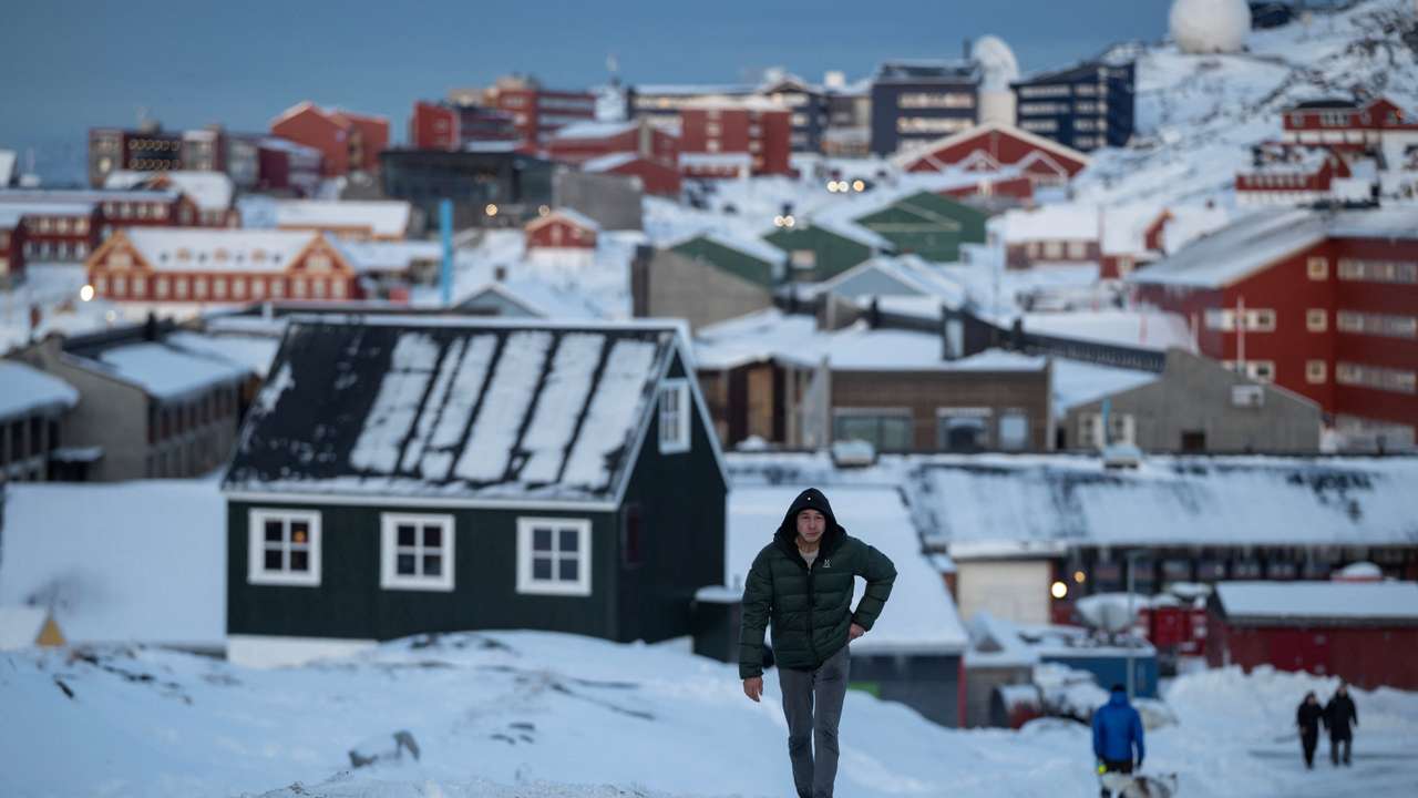 A man walks along a road on the day of the meeting between top U.S. officials and the foreign ministers of Denmark and Greenland, in Nuuk