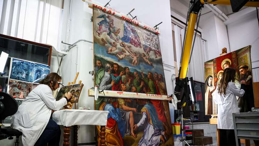 Art restorers work at the "painting and wood materials restoration laboratory" in the Vatican Museums, at the Vatican