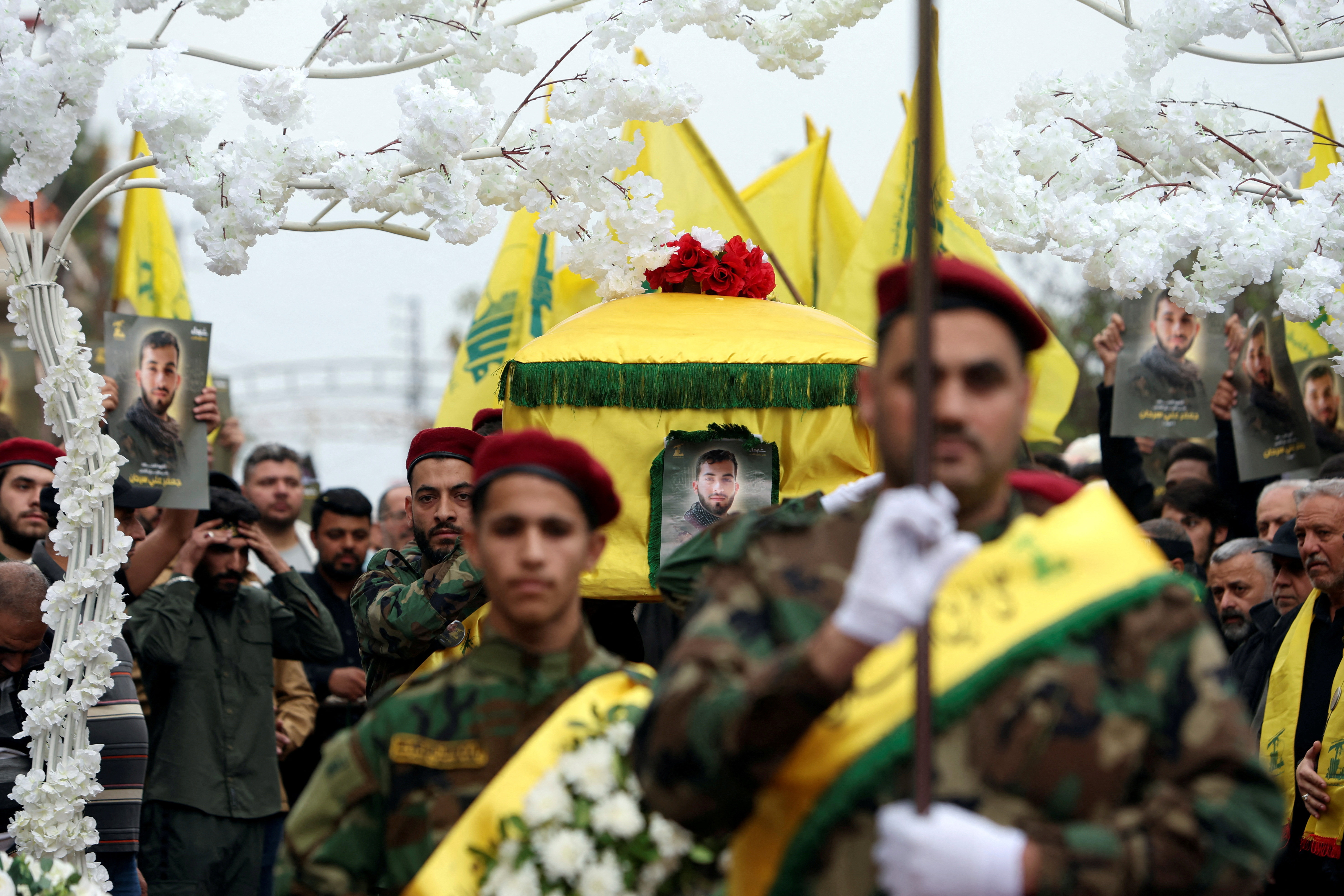 FILE PHOTO: Members of Hezbollah carry the coffin of Hezbollah member Jaafar Serhan, during his funeral in Mashghara