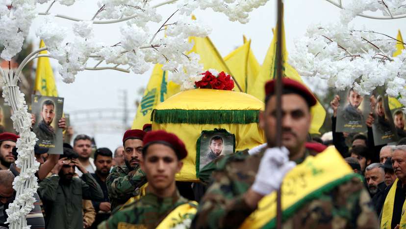 FILE PHOTO: Members of Hezbollah carry the coffin of Hezbollah member Jaafar Serhan, during his funeral in Mashghara