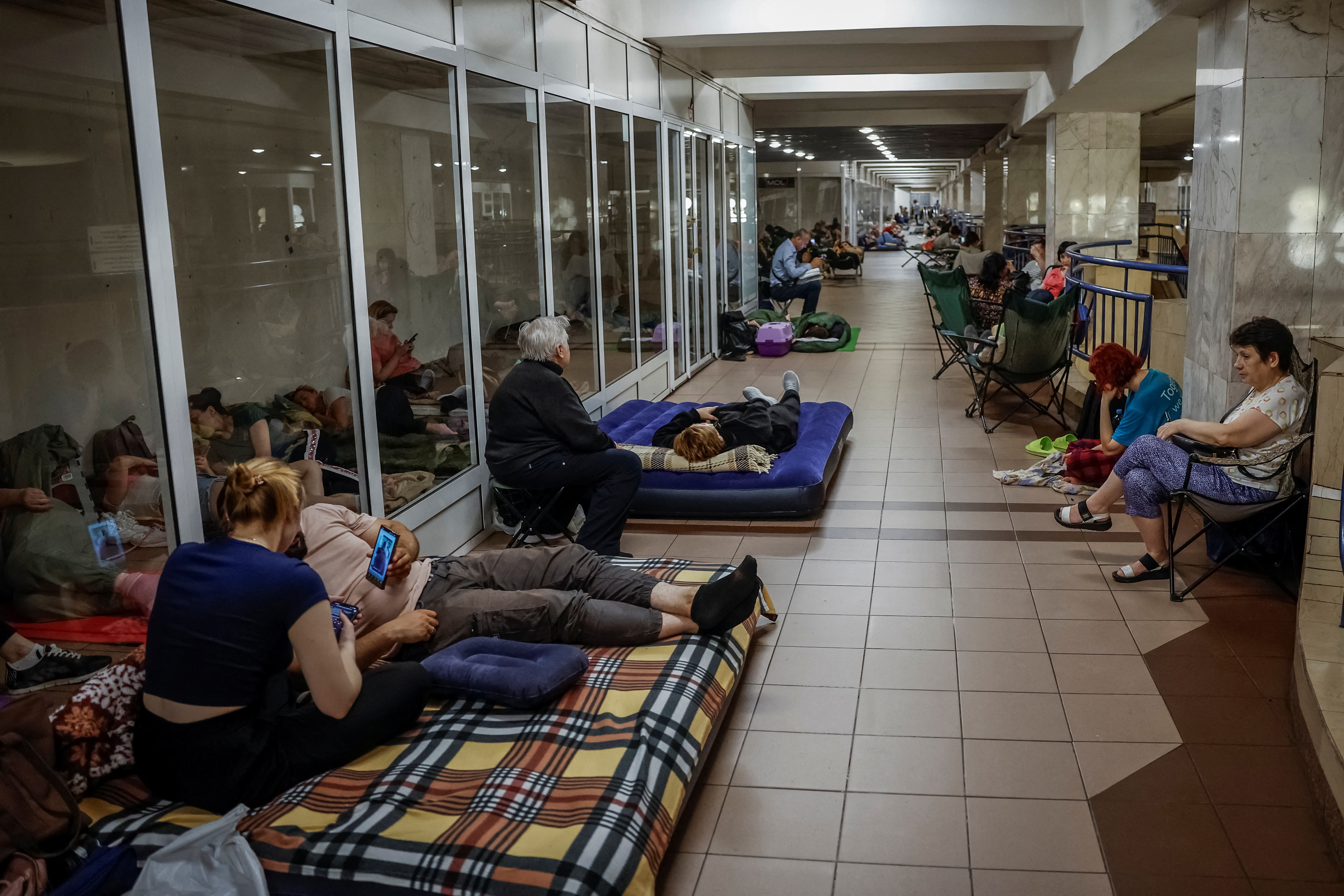 People take shelter inside a metro station during an air raid alert in Kyiv