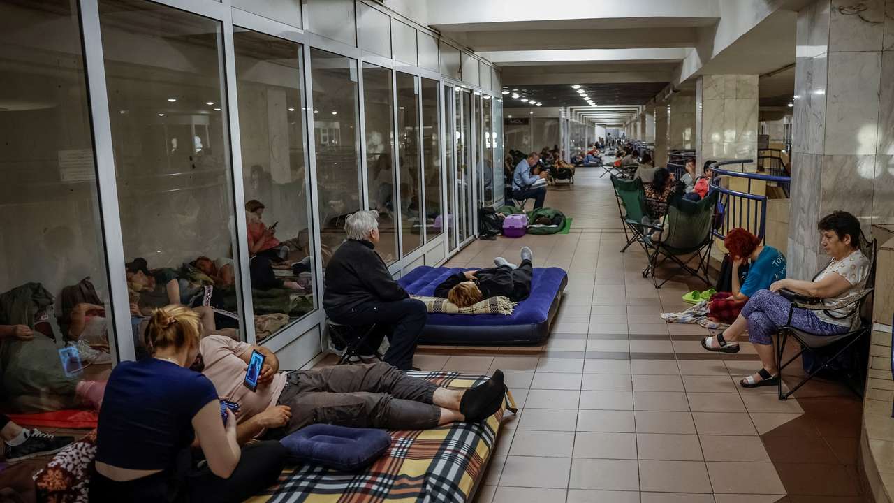 People take shelter inside a metro station during an air raid alert in Kyiv