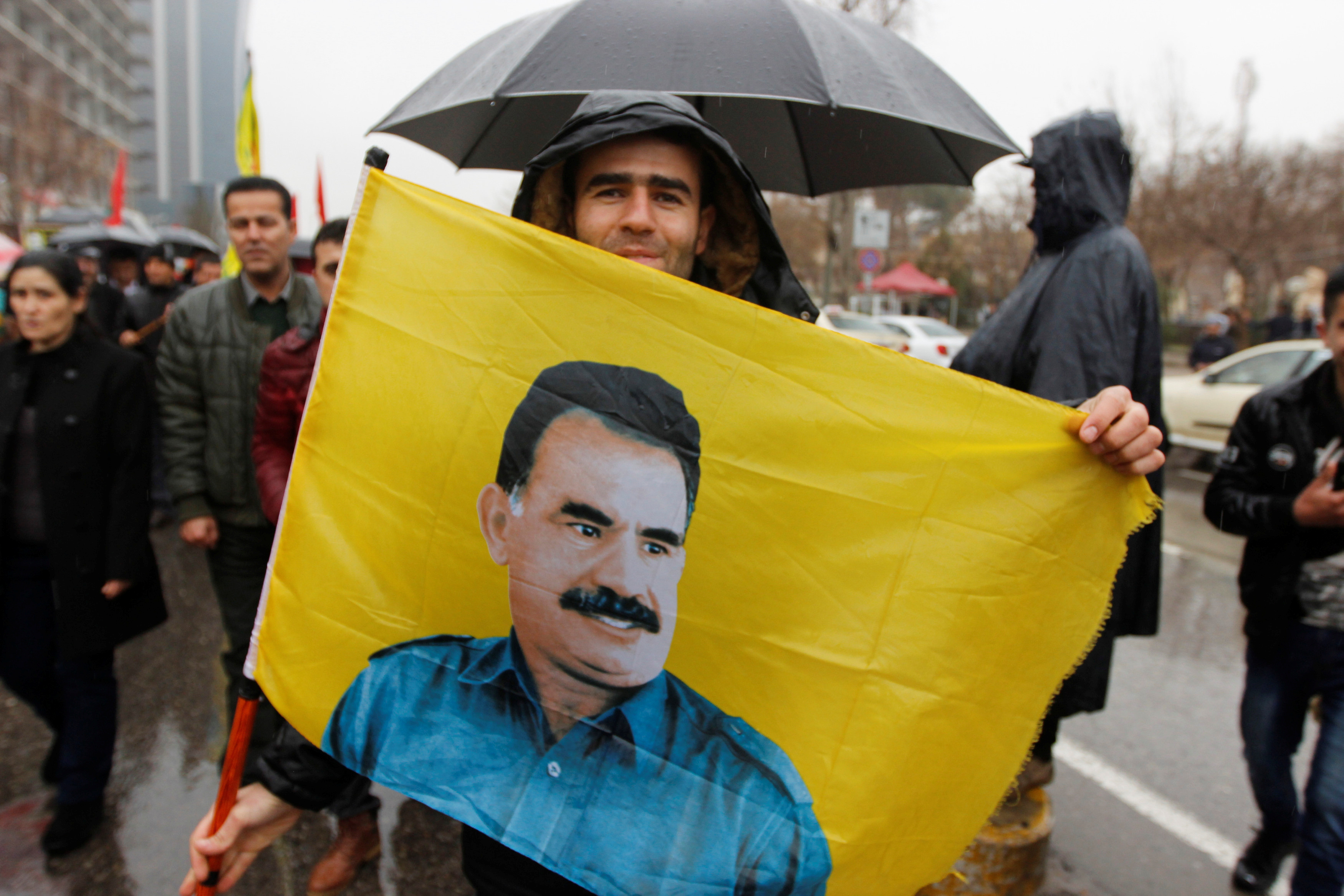 A Kurdish demonstrator holds a flag during a protest demanding the release of the Kurdistan Workers Party (PKK) leader Abdullah Ocalan, in Sulaimaniyah