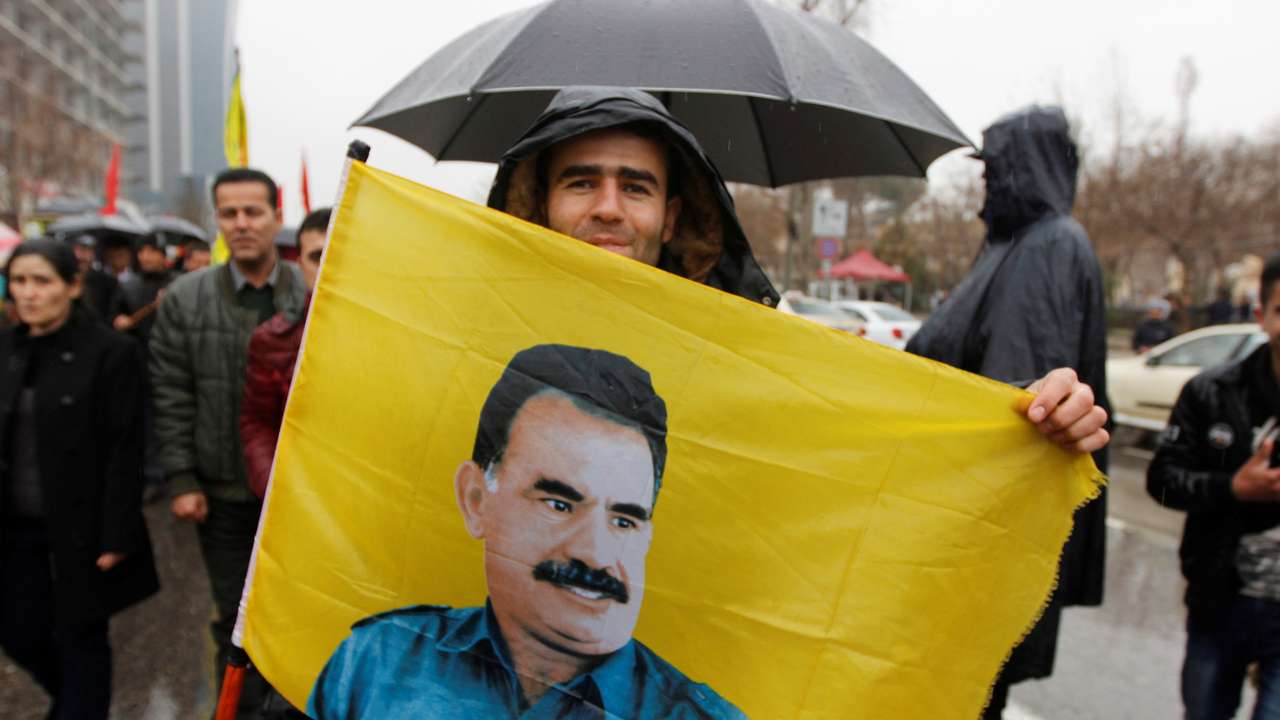 A Kurdish demonstrator holds a flag during a protest demanding the release of the Kurdistan Workers Party (PKK) leader Abdullah Ocalan, in Sulaimaniyah