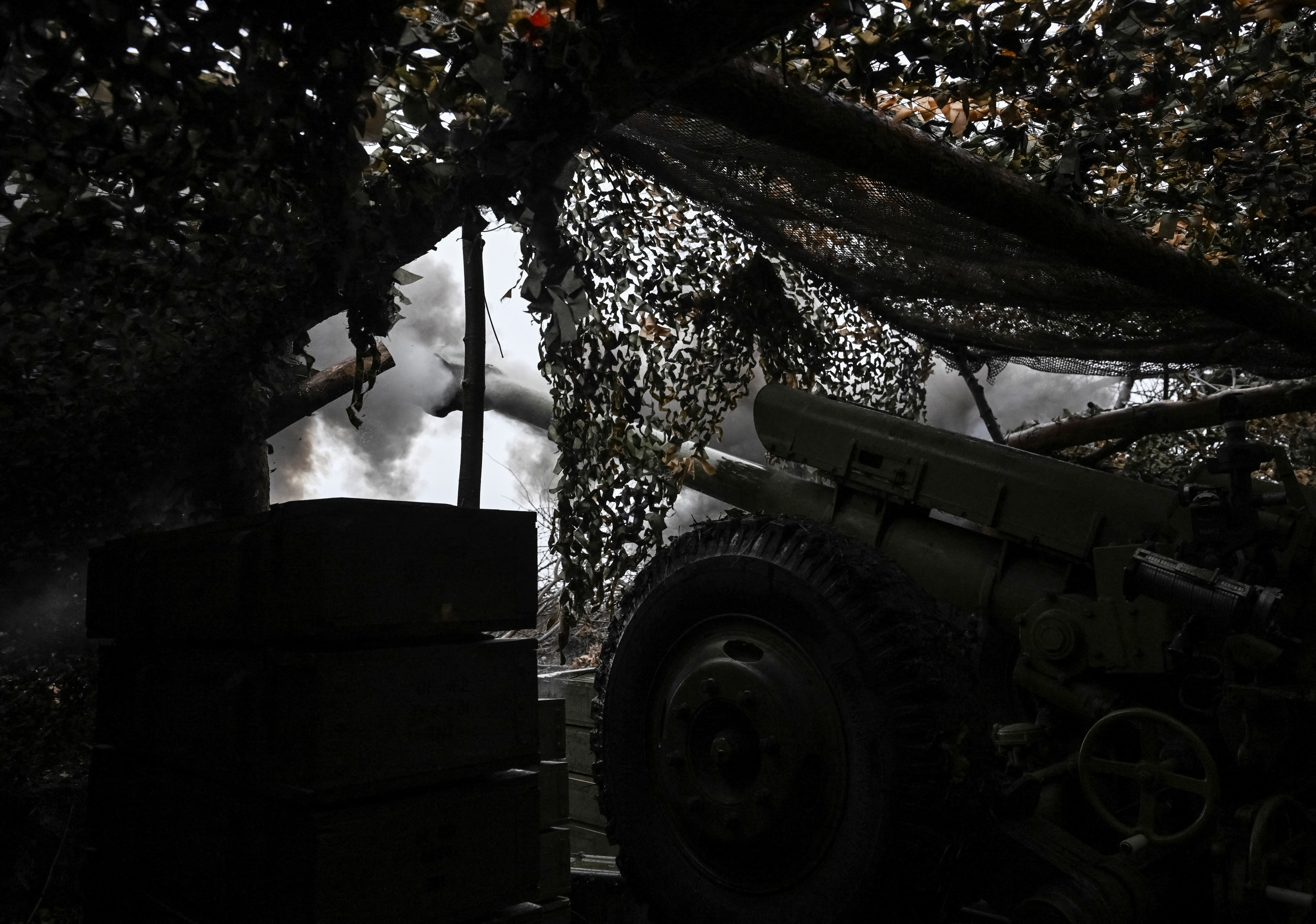 Ukrainian servicemen fire a howitzer towards Russian troops at a position in a front line near the town of Pokrovsk