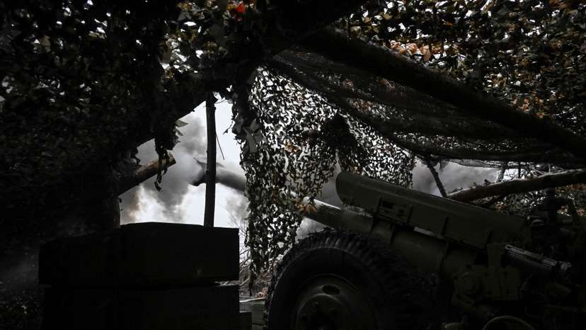 Ukrainian servicemen fire a howitzer towards Russian troops at a position in a front line near the town of Pokrovsk