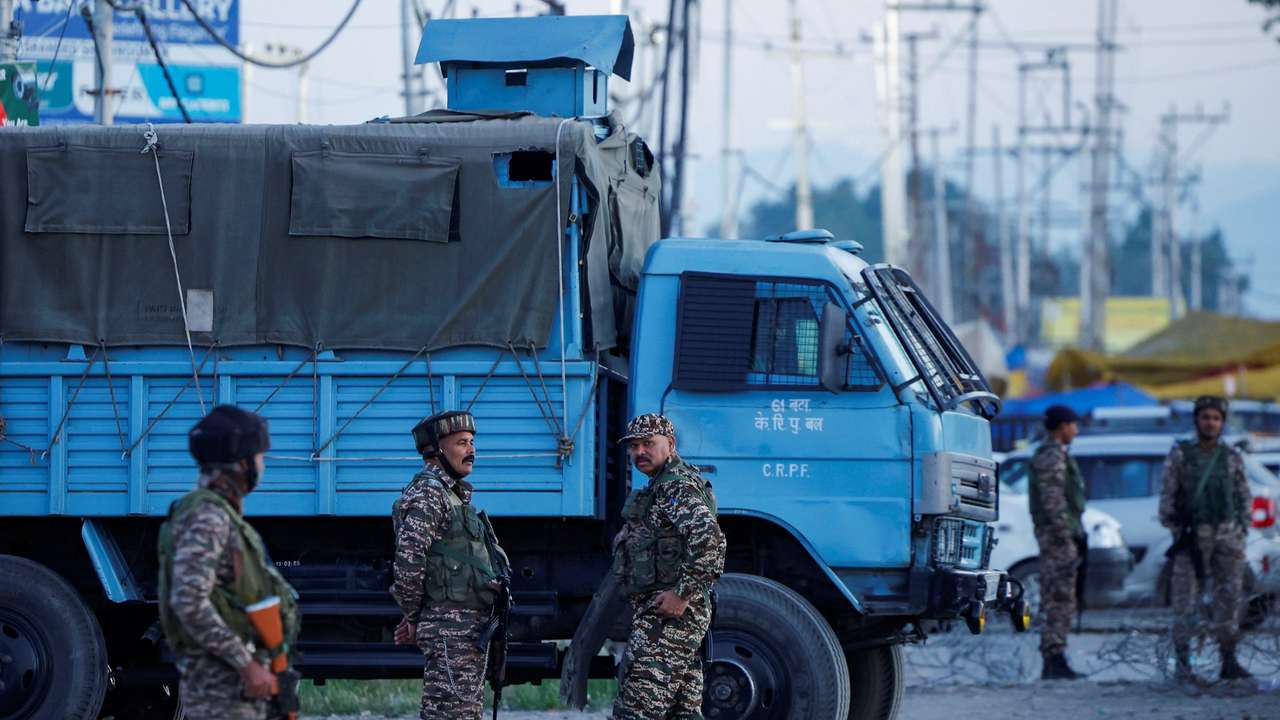 Indian security personnel stand guard on a road outside the Haj House as pilgrims depart for Mecca for the annual pilgrimage to the holiest place for Muslims, in Srinagar