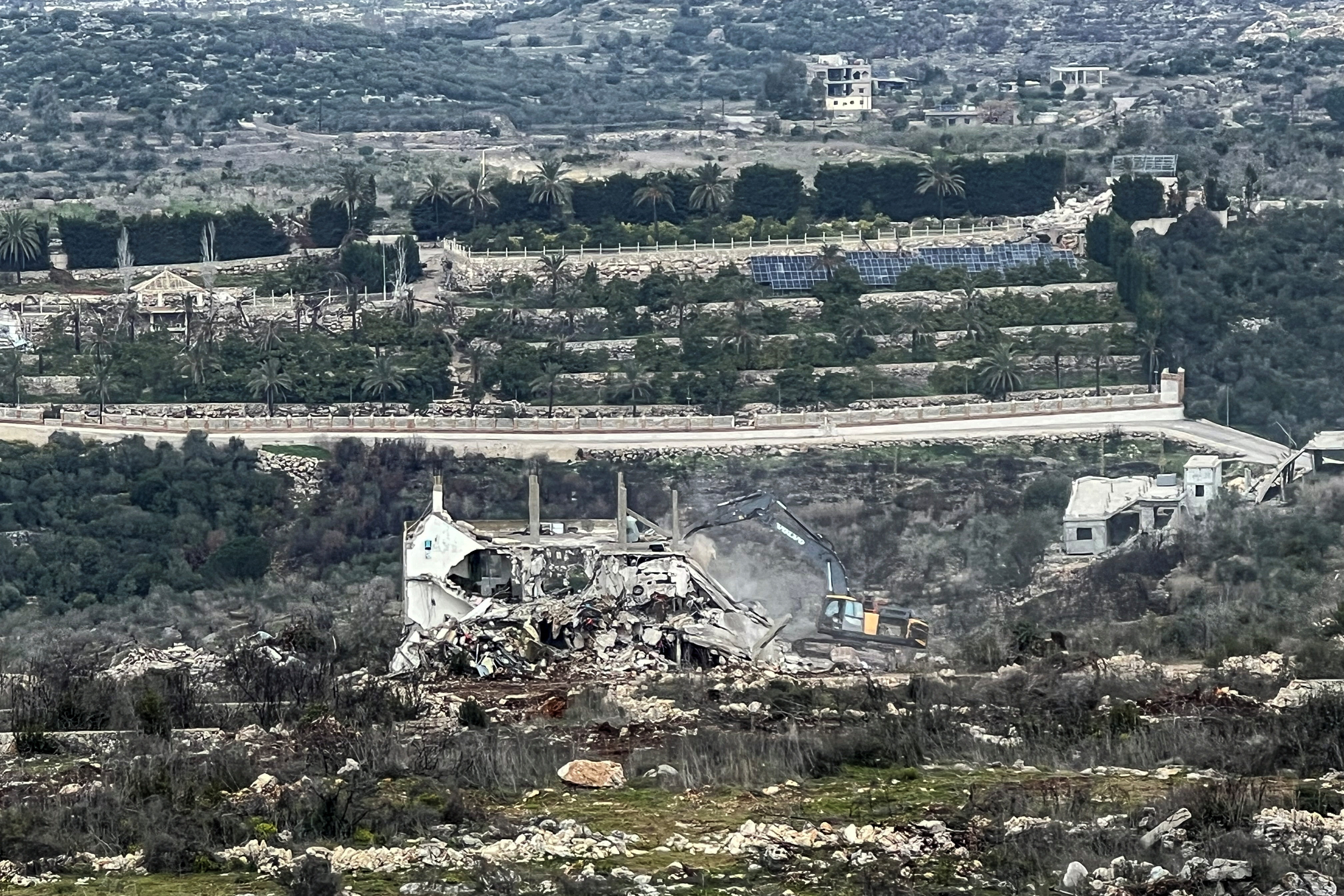 An Israeli military bulldozer works on the Lebanese side of the border between Israel and Lebanon, as seen from Israel