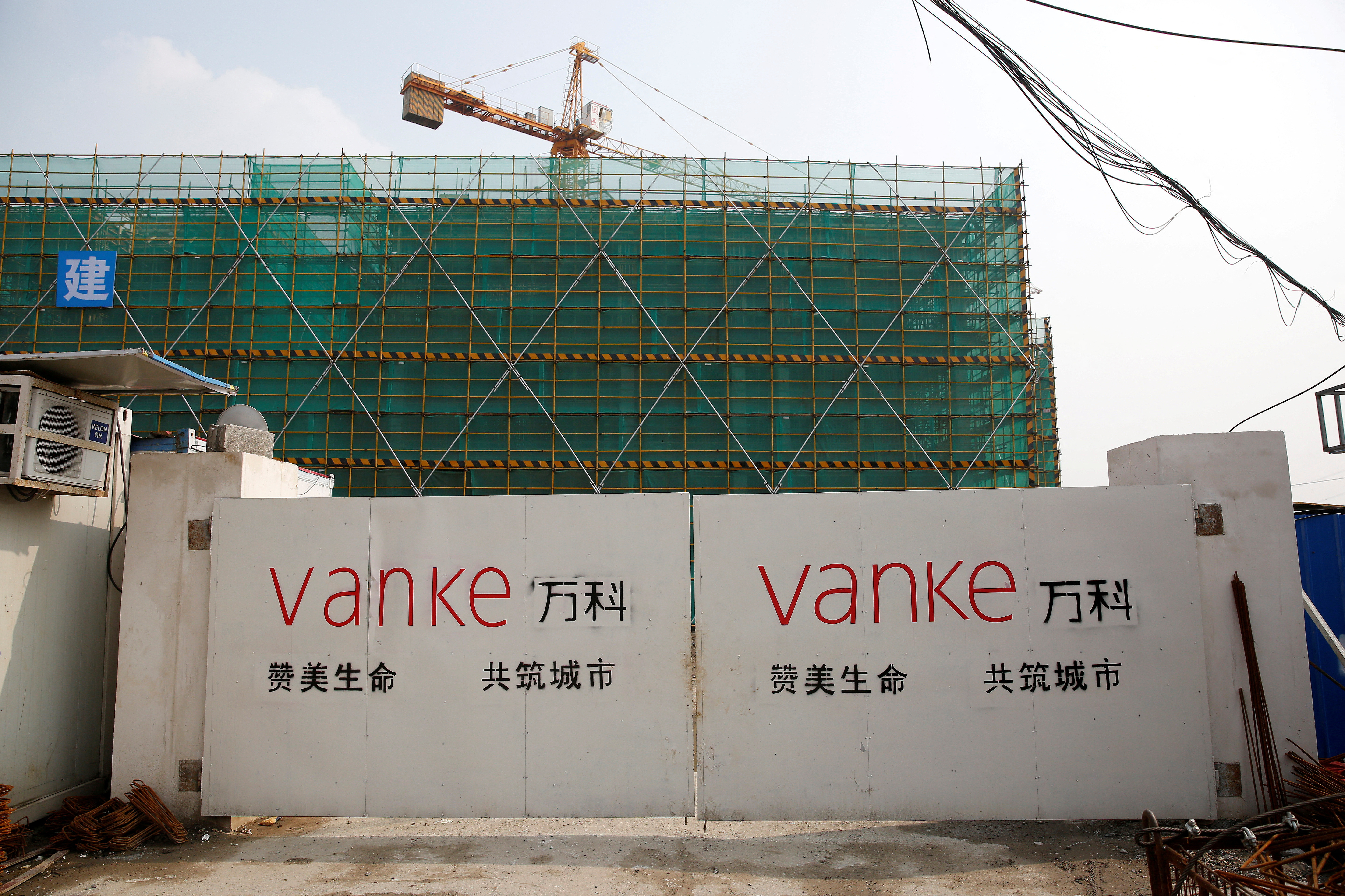 FILE PHOTO: Sign of Vanke is seen at a gate of a construction site in Shanghai