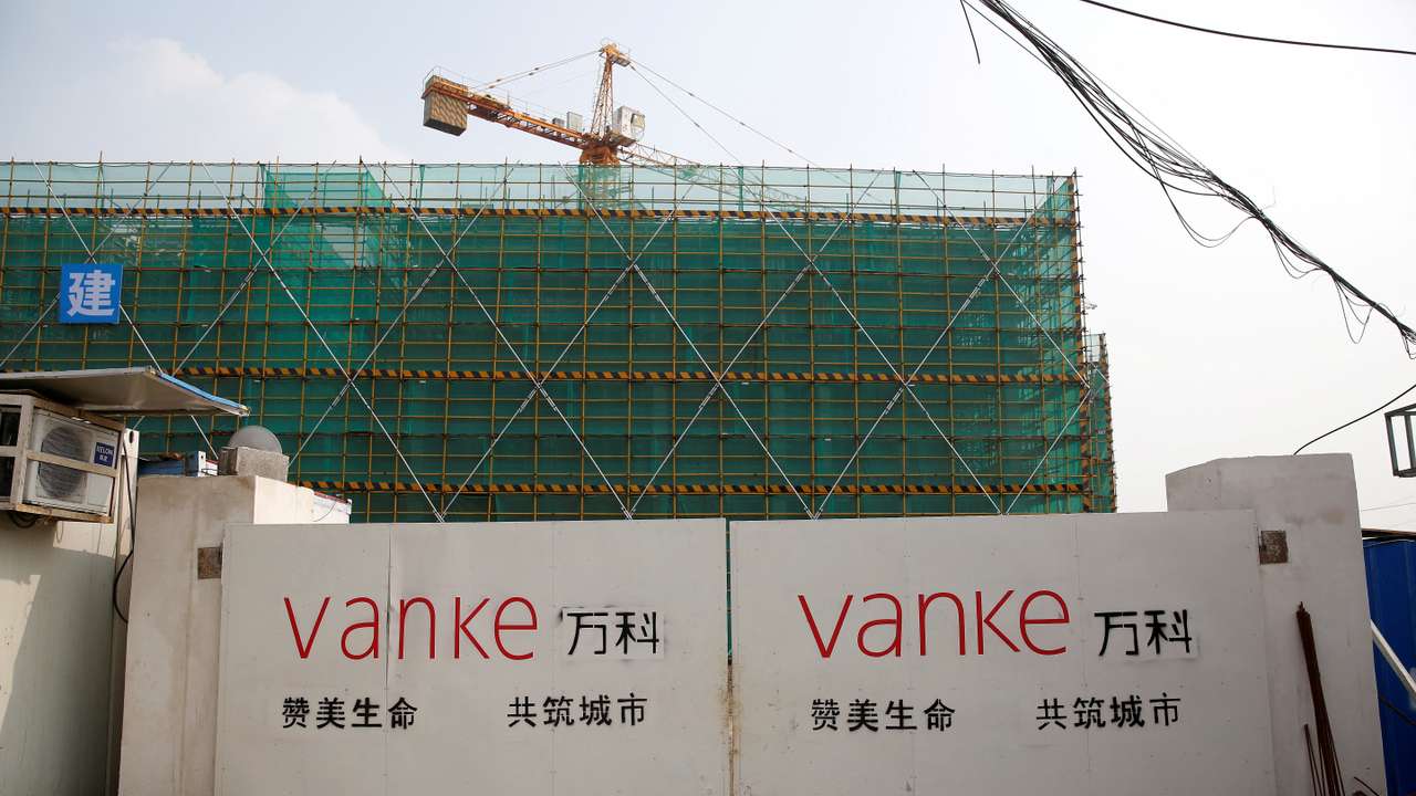 FILE PHOTO: Sign of Vanke is seen at a gate of a construction site in Shanghai