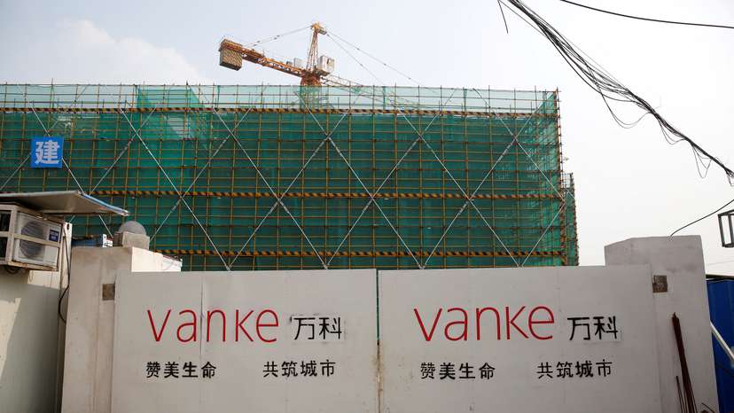 FILE PHOTO: Sign of Vanke is seen at a gate of a construction site in Shanghai