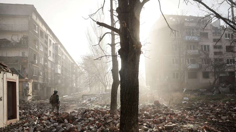 FILE PHOTO: Ukrainian serviceman walks near apartment buildings damaged by a Russian military strike in the frontline town of Kostiantynivka