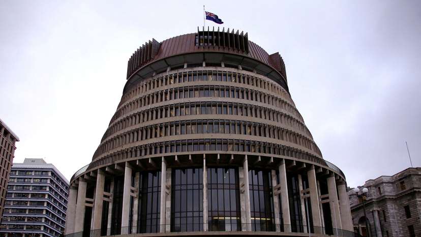 FILE PHOTO: A pedestrian walks past the New Zealand parliament building known as the Beehive in central Wellington, New Zealand