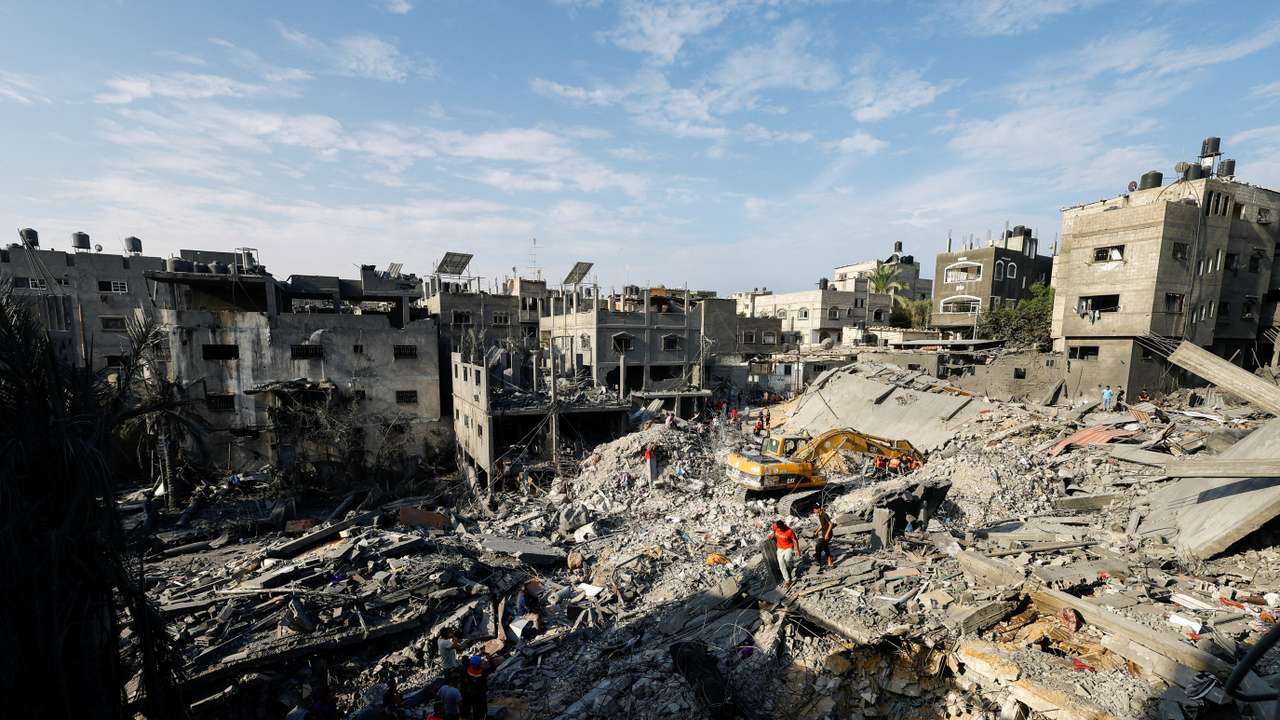 Emergency personnel work at the site of Israeli strikes on houses, in Khan Younis