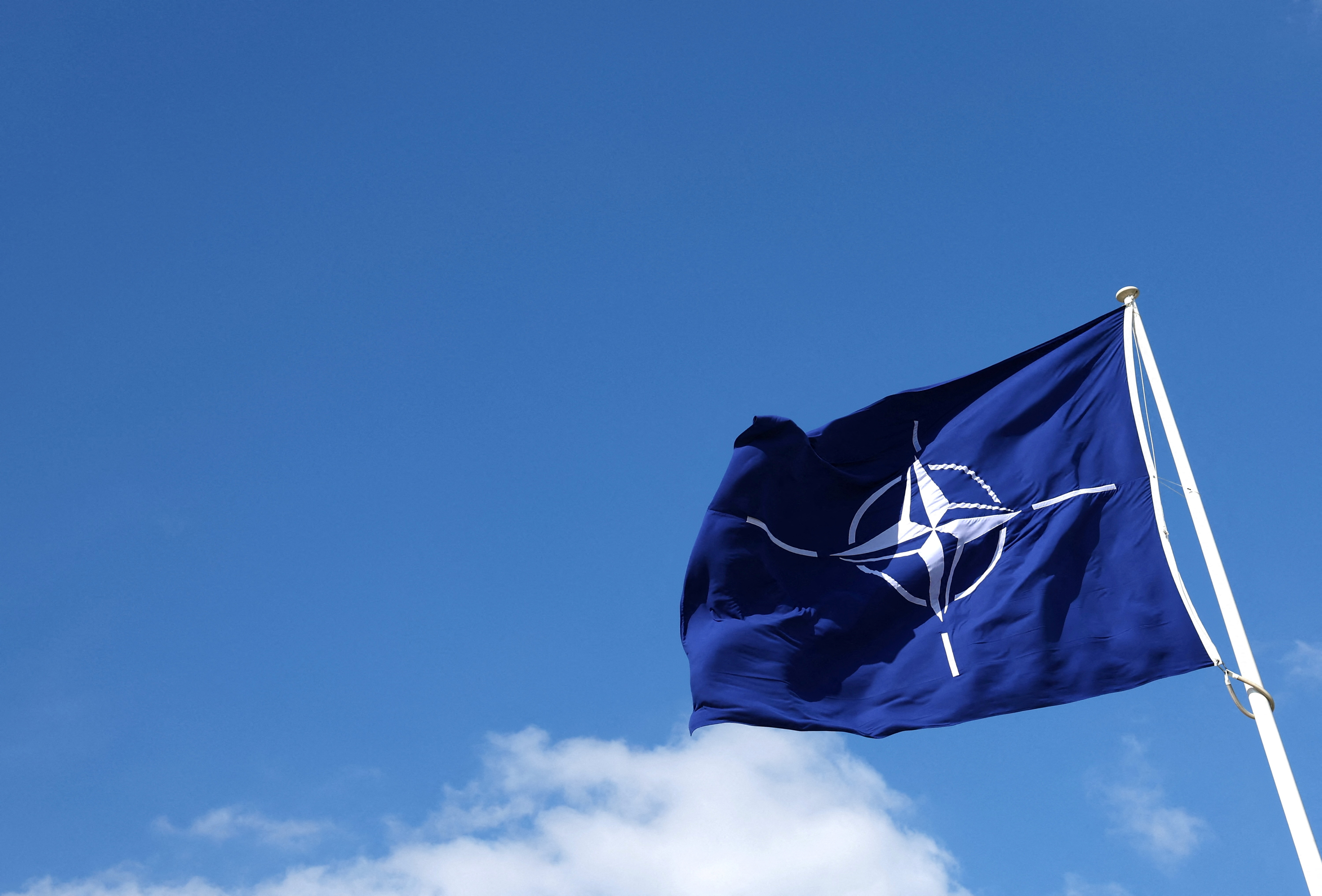 FILE PHOTO: A NATO flag flutters at NATO headquarters in Brussels