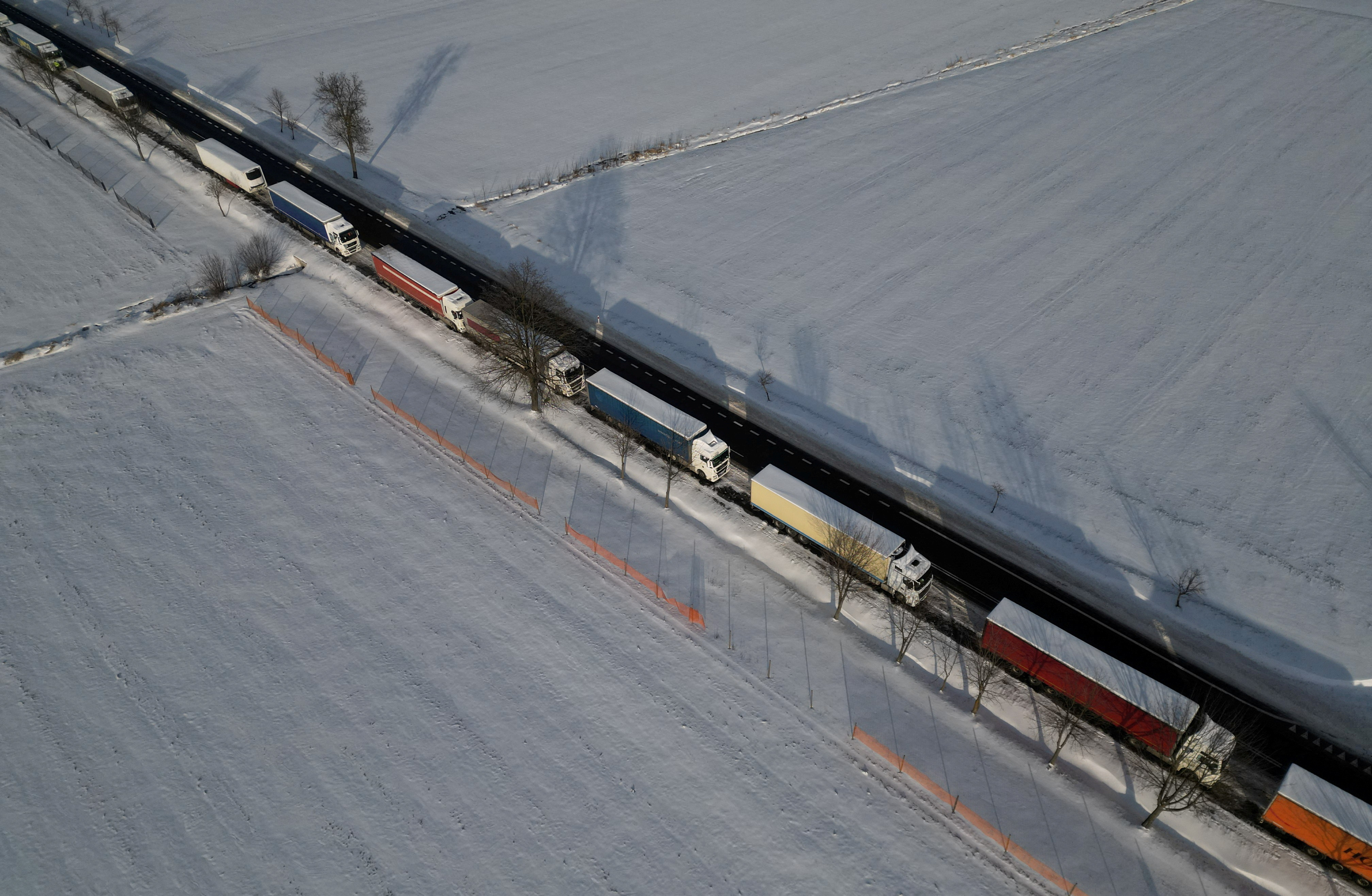FILE PHOTO: Trucks line up in a long queue to cross the Polish-Ukrainian border at the Hrebenne-Rawa Ruska crossing in Potoki