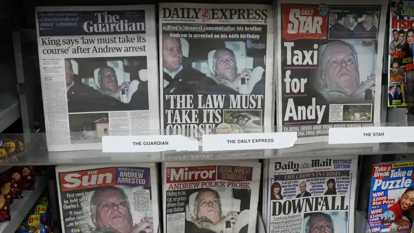 British newspapers, featuring coverage of the arrest of Andrew Mountbatten-Windsor, younger brother of Britain's King Charles, on suspicion of misconduct in public office, sit on display in a newsagent in London
