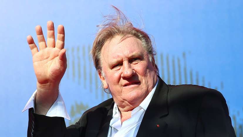 Gerard Depardieu waves as he arrives during a red carpet event for the movie "Novecento- Atto Primo" at the 74th Venice Film Festival in Venice