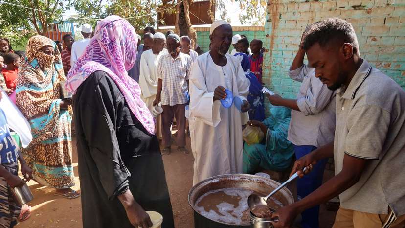 FILE PHOTO: Volunteers distribute food to residents and displaced people in Omdurman