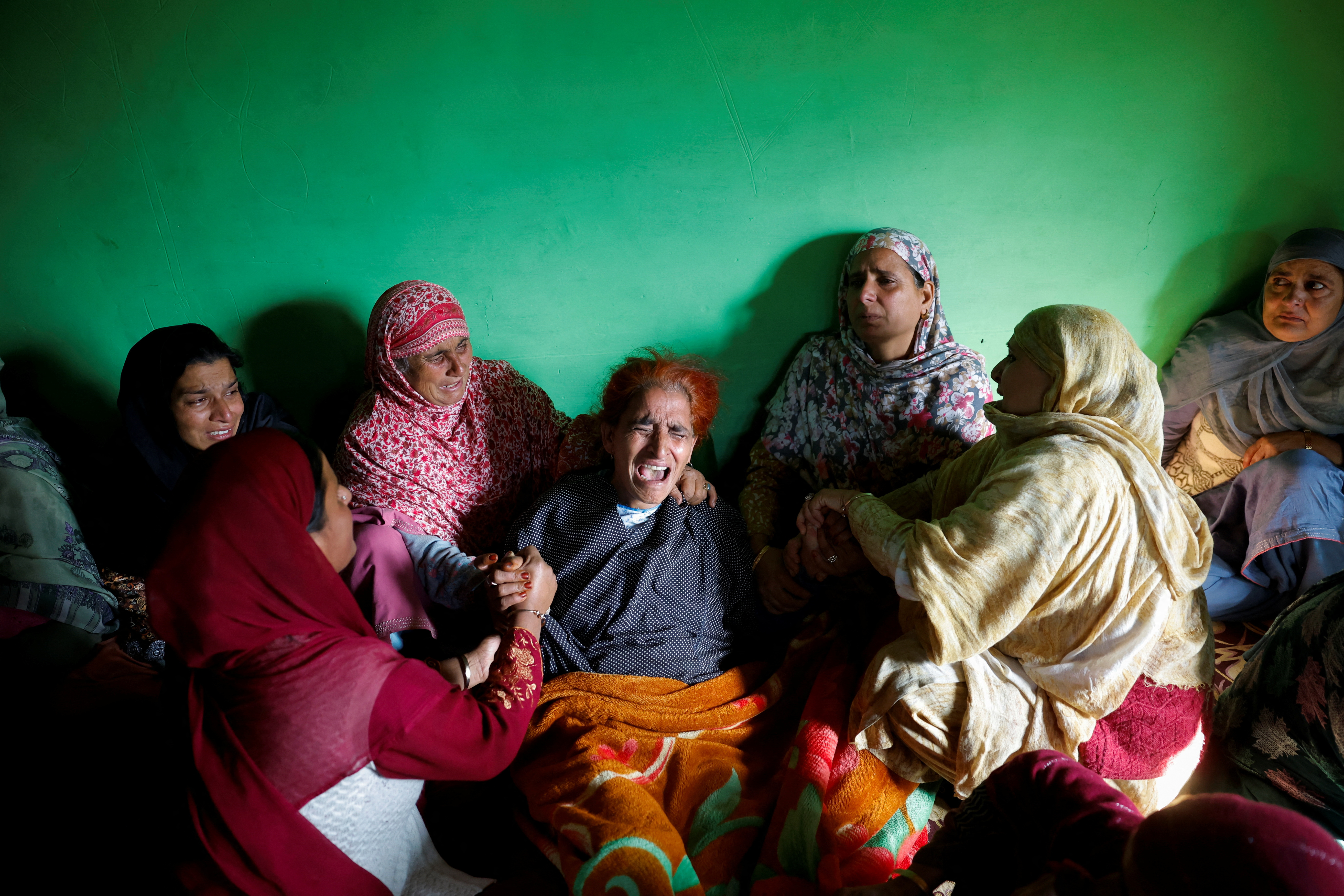 Relatives console the mother of Zahoor Ahmad Mir, an army porter who was killed in a militant attack in the Bota Pathri area, before his funeral in north Kashmir’s Baramulla district