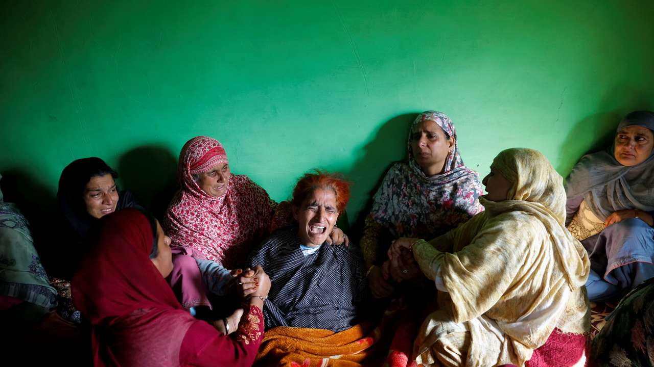 Relatives console the mother of Zahoor Ahmad Mir, an army porter who was killed in a militant attack in the Bota Pathri area, before his funeral in north Kashmir’s Baramulla district
