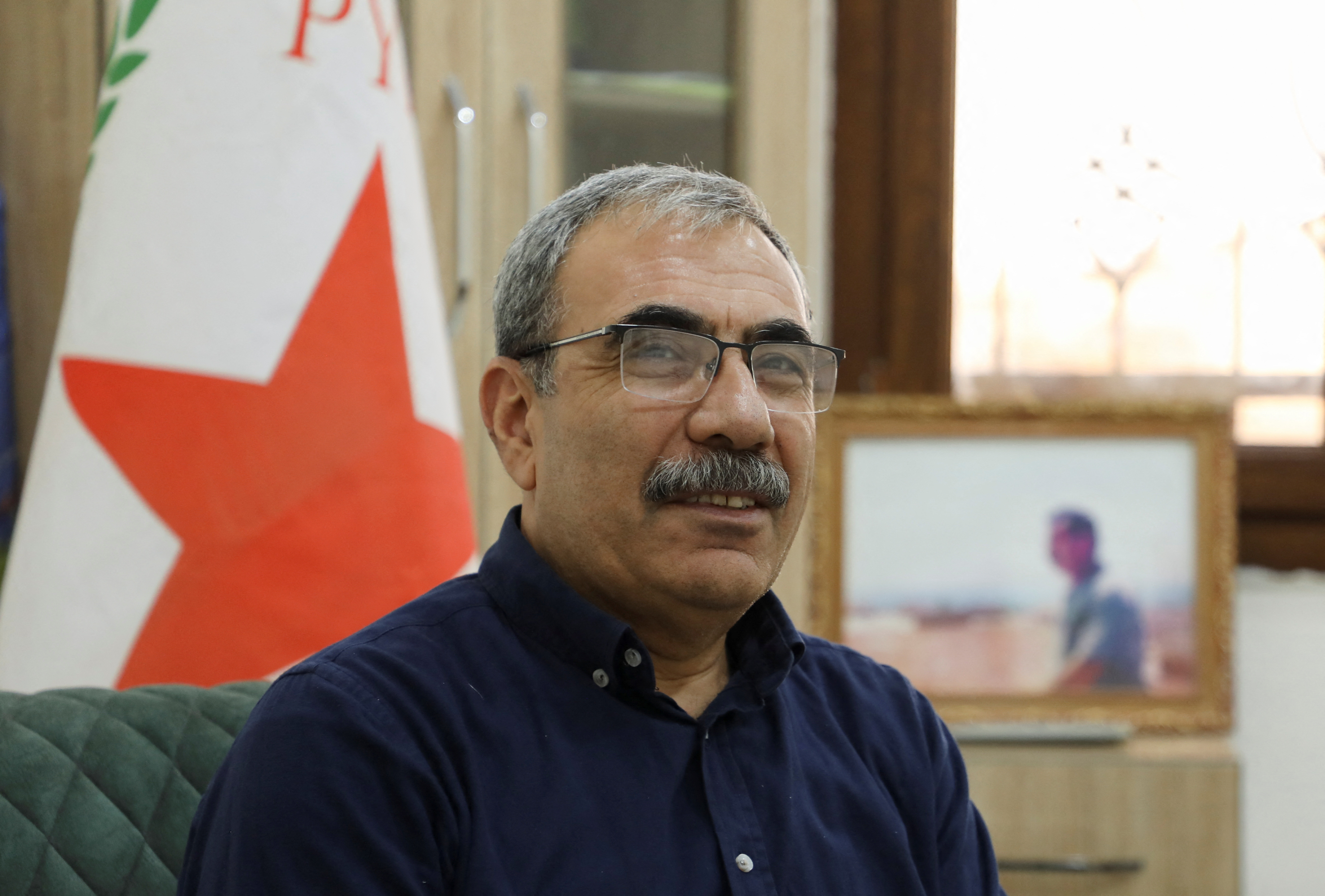 Aldar Xelil of Democratic Union Party (PYD) attends an interview with Reuters at his office in Hasaka